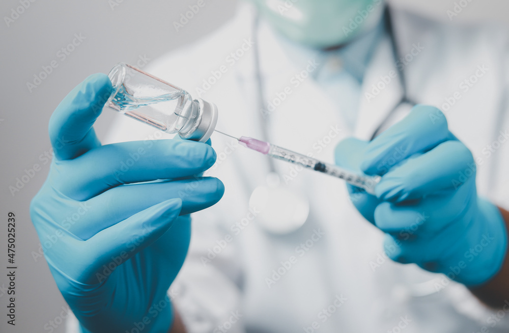 A doctor or scientist in the COVID-19 medical vaccine research and development laboratory holds a syringe with a liquid vaccine to study and analyze antibody samples for the patient.
A doctor or scientist in the COVID-19 medical vaccine research and development laboratory holds a syringe with a liquid vaccine to study and analyze antibody samples for the patient.