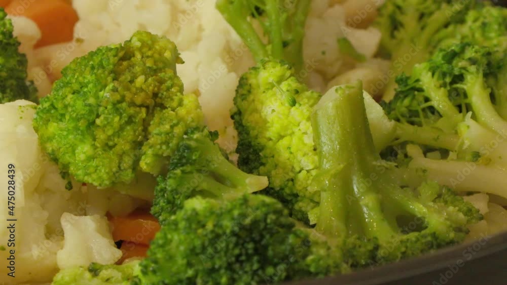 broccoli cauliflower carrots onions roasting in a pan broccoli cauliflower carrots onions roasting in a pan