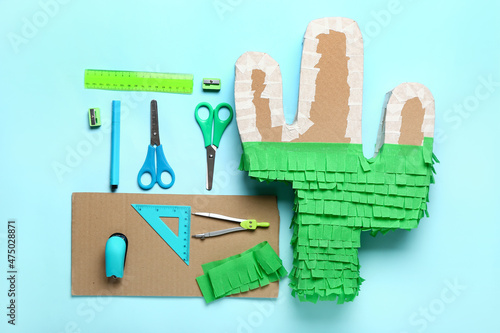Preparation of Mexican pinata on color background