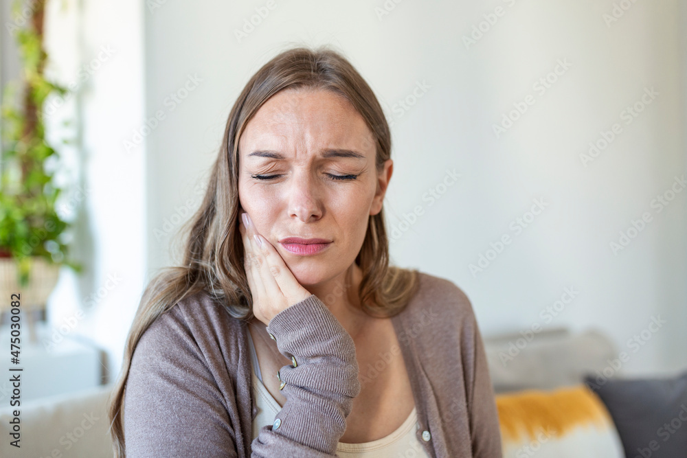 Tooth Pain And Dentistry. Young Woman Suffering From Terrible Strong Teeth Pain, Touching Cheek With Hand. Female Feeling Painful Toothache. Dental Care And Health Concept. Tooth Pain And Dentistry. Young Woman Suffering From Terrible Strong Teeth Pain, Touching Cheek With Hand. Female Feeling Painful Toothache. Dental Care And Health Concept.