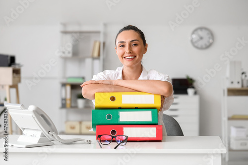 Young woman working with documents in office photo