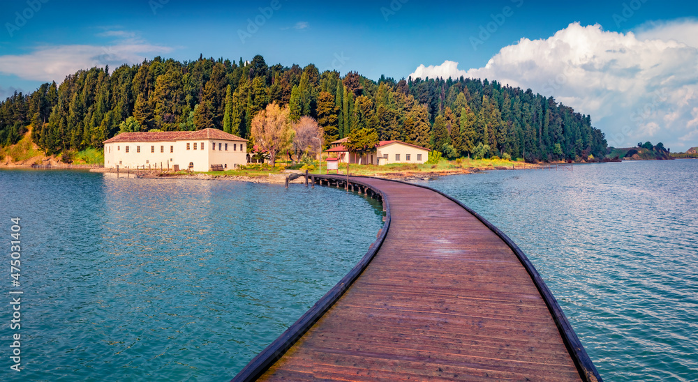 Wooden pier to St Mary's Monastery. Attractive spring seascape of Narta Lagoon. Spectacular outdoor scene of Albania, Europe. Traveling concept background.