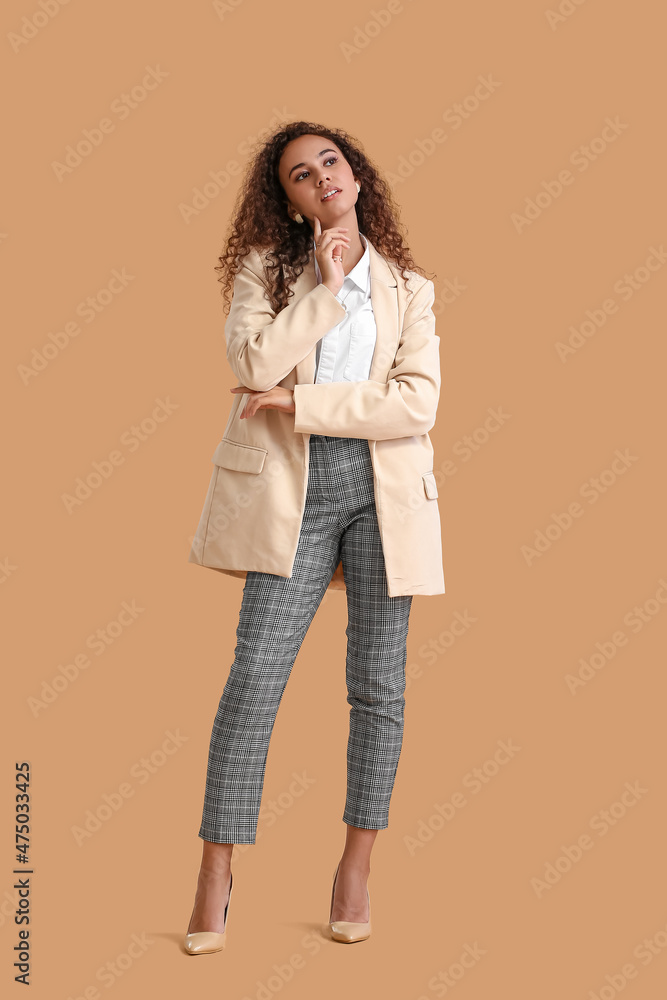 Fashionable African-American woman on color background Fashionable African-American woman on color background