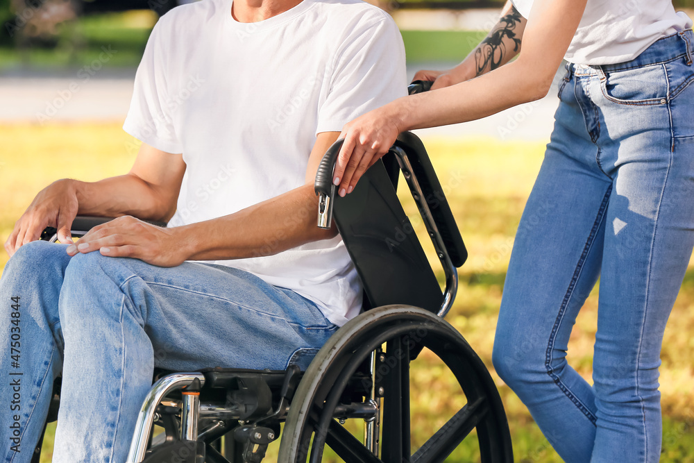 Obraz premium Young man with physical disability and his wife in park