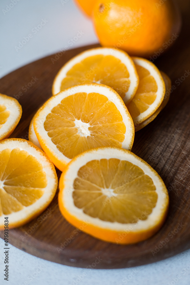 Slices of orange juicy orange on a cutting wooden board. Sliced fruit. Vitamins. Slices of orange juicy orange on a cutting wooden board. Sliced fruit. Vitamins.