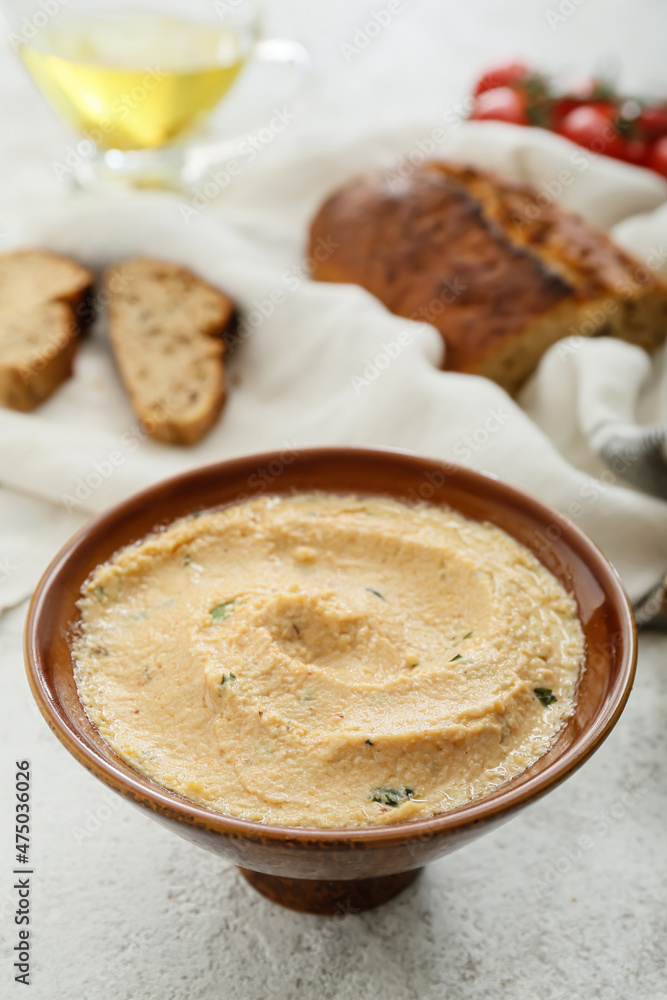 Bowl with delicious hummus on light background, closeup Bowl with delicious hummus on light background, closeup