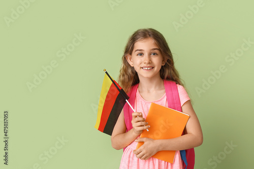 Pupil of language school with German flag on color background