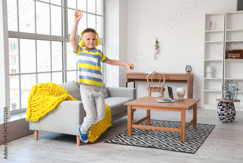 Cute little boy listening t...