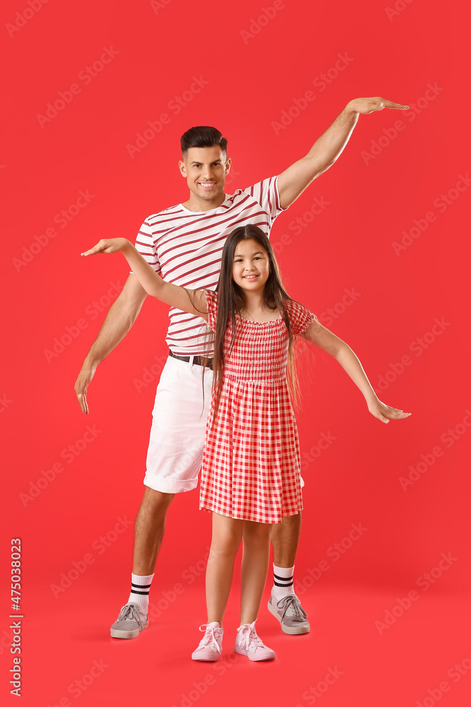 Dancing man and his little daughter on color background Dancing man and his little daughter on color background