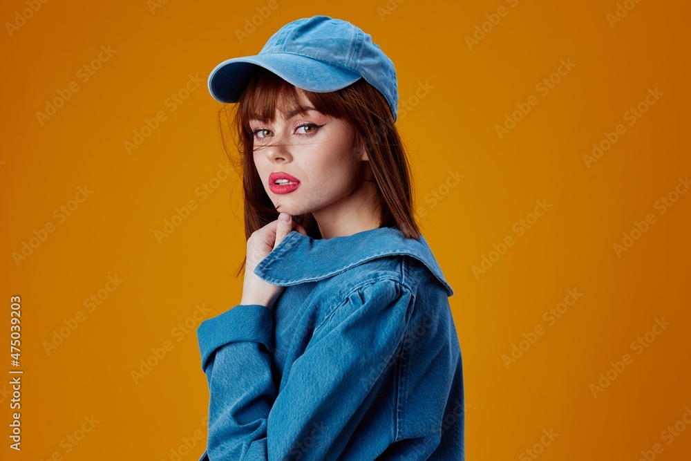 Portrait of a charming lady denim clothing fashion posing cap color background unaltered Portrait of a charming lady denim clothing fashion posing cap color background unaltered