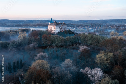 Aerial view of the Olesko castle. A very beautiful castle in foggy dark weather. Lviv region, Ukraine. Tourism, travel.