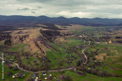 Aerial view of a narrow winding road through the beautiful wooded Carpathians, amazing spring landscape, outdoor tourist background, Transcarpathia, Ukraine photo