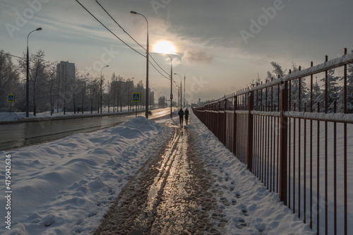 Slushy sidewalk in December after sprinkling chemicals against ice © Valery Kleymenov