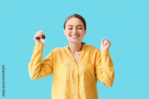 Happy young woman with key ...