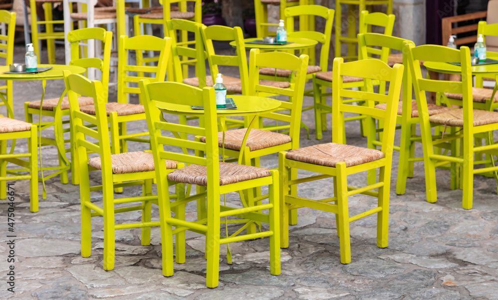 Cafe bar open air. Empty seats on cobblestone street background, Areopoli, Mani Greece