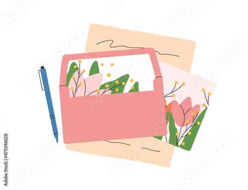 Open envelope with paper handwritten letter and greeting postcard composition...