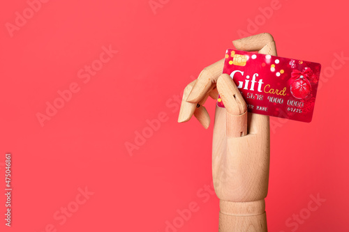 Wooden hand with gift card ...