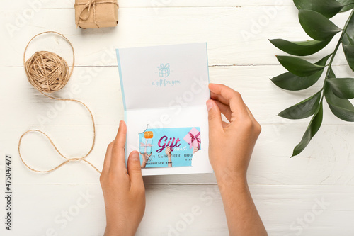 Female hands with gift card...