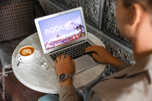 Young man booking hotel roo...