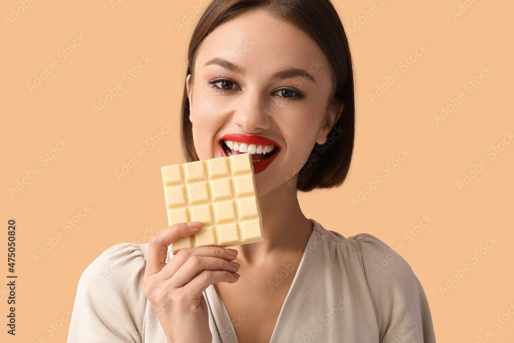 Beautiful woman with sweet chocolate on color background Beautiful woman with sweet chocolate on color background