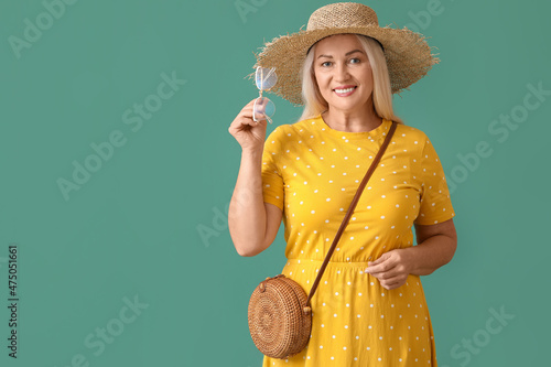 Mature woman in straw hat h...