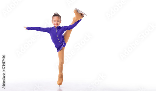 A Little young figure skater posing in blue training dress on ice on white background photo