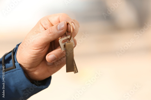 Man holding key on chain ou...