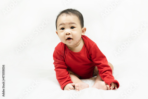 Cute infant baby boy toddler in red bodysuit.Concept holiday Christmas, happy new year, infants, childhood.