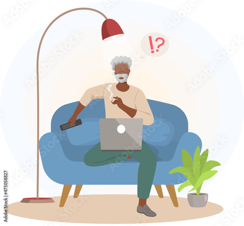 Old man sitting with computer and smoking on couch. Senior person dealing with technology, using modern gadgets, relaxing at home. Male character has difficulties, questions in work with laptop