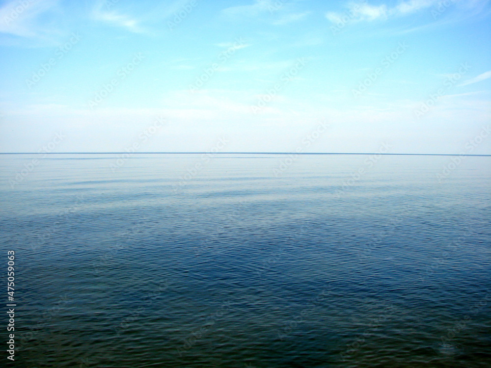 Panorama of the boundless wrinkled sea surface connecting with the blue cloudless sky on the horizon. Panorama of the boundless wrinkled sea surface connecting with the blue cloudless sky on the horizon.