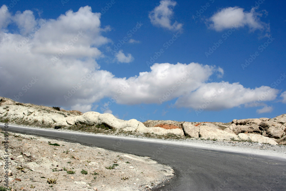 asphalt mountain road and blue sky