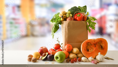 Fototapeta Naklejka Na Ścianę i Meble -  Recyclable shopping bag with fruits and vegetables with supermarket background