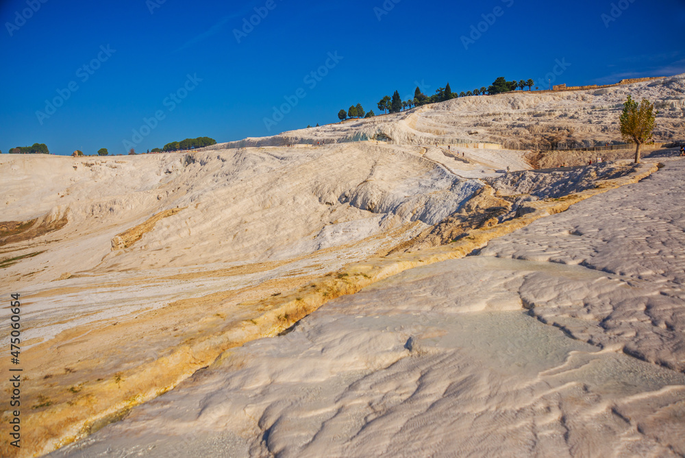 PAMUKKALE, TURKEY: Beautiful white travertine terraces on a sunny day. PAMUKKALE, TURKEY: Beautiful white travertine terraces on a sunny day.