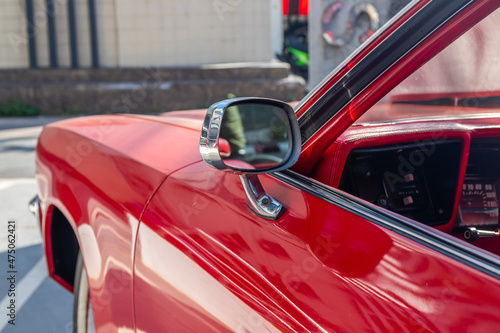The vehicle's wing mirror of a red classic car or Muscle car photo