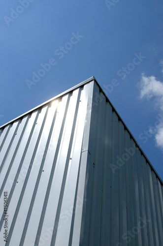 Corner of metal container against sky
