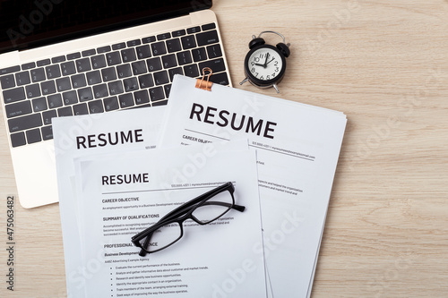 Quadro su tela Resumes on laptop with glasses resume review, job interview