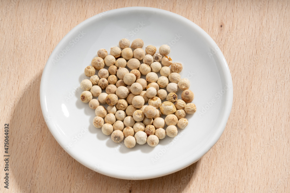 Detailed and large close up shot of peppercorns on a small plate Detailed and large close up shot of peppercorns on a small plate