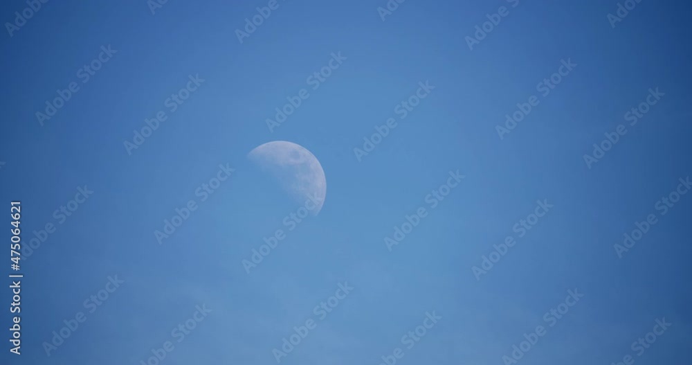 Time lapse of Huge moon against a blue sky
