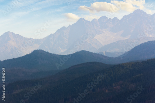 Fototapeta Naklejka Na Ścianę i Meble -  beautiful nature background of High Tatra ridge. scenic landscape view in evening light. clouds on the sky above the peaks. outdoor adventure concept