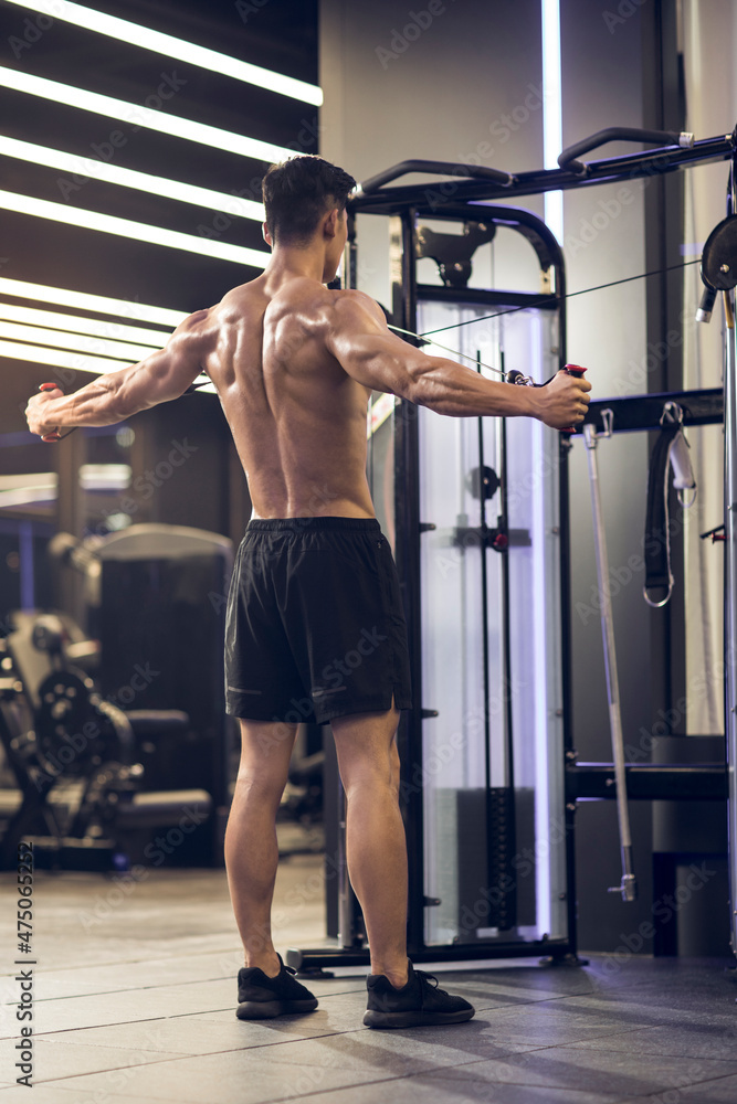 Young man exercising at gym Young man exercising at gym