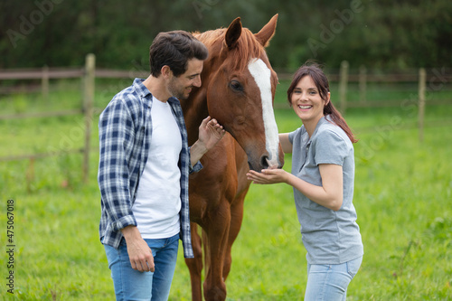 two lovers in a field with a horse