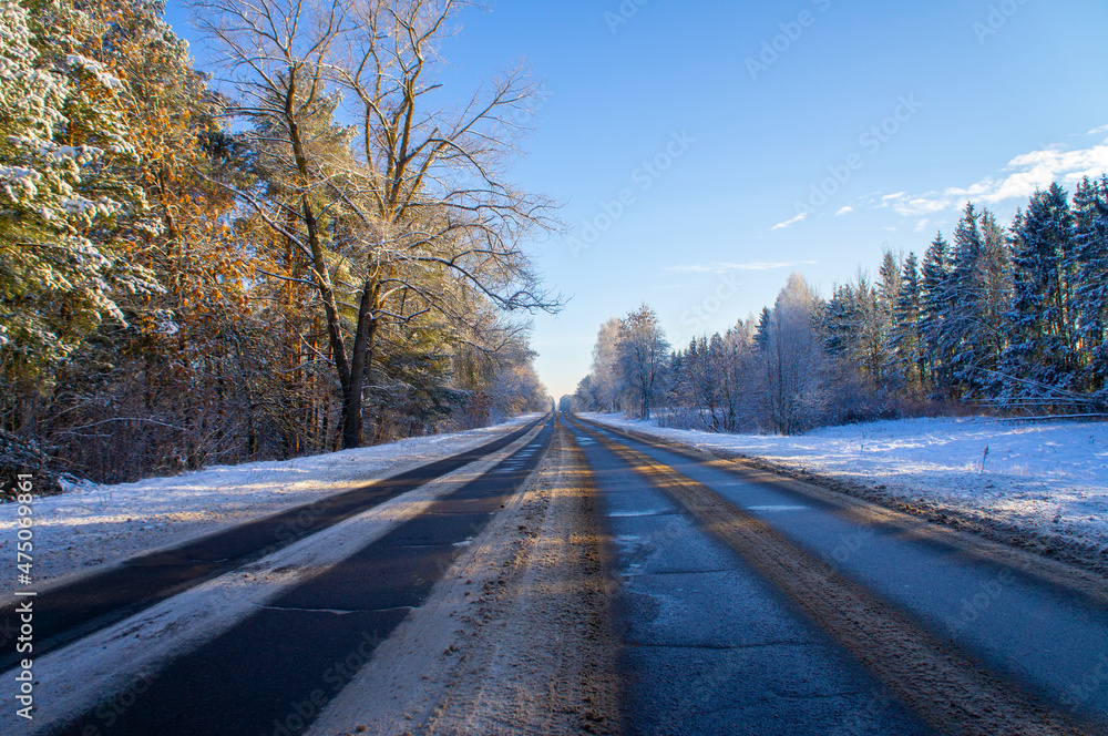 Beautiful empty winter snow road on a sunny cold day Beautiful empty winter snow road on a sunny cold day