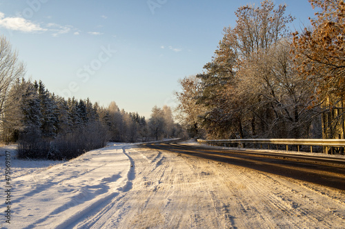 Beautiful empty winter snow road on a sunny cold day © Payllik