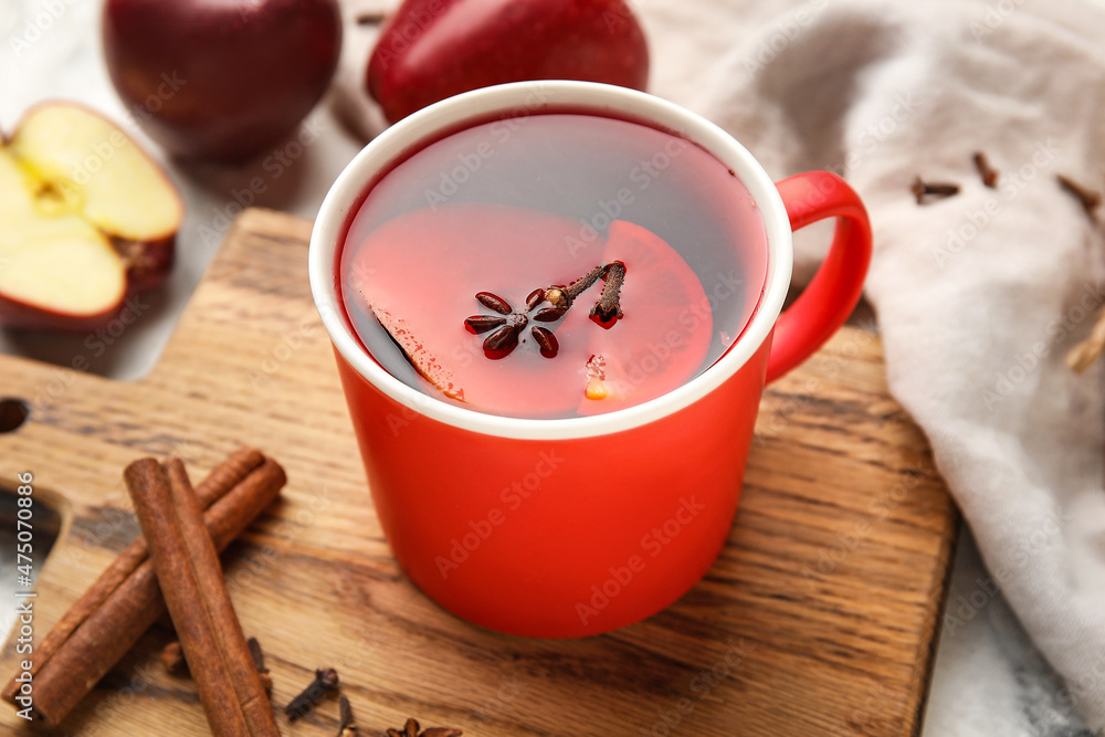 Cup of tasty fruit tea with cinnamon on table Cup of tasty fruit tea with cinnamon on table