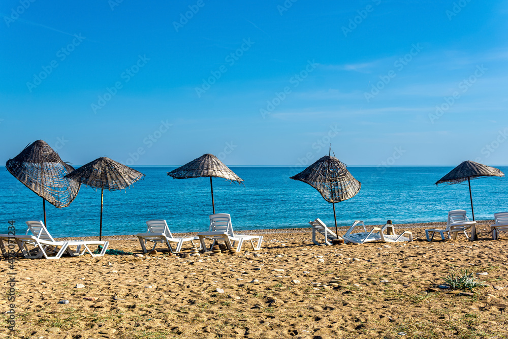 rickety parasols and broken sunbeds on a deserted abandoned beach rickety parasols and broken sunbeds on a deserted abandoned beach