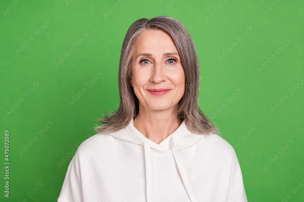 Fototapeta premium Photo of pretty adorable senior lady wear white hoodie smiling isolated green color background