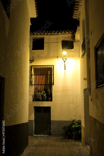Narrow street and typical facades at night of Benimantell village
