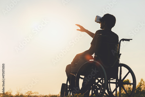 Disabled person in wheelchair wearing vr goggles and enjoying game, technology.