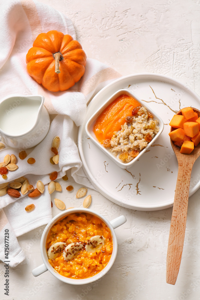 Pot and bowl of tasty oatmeal with pumpkin on white background Pot and bowl of tasty oatmeal with pumpkin on white background