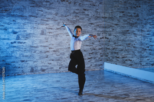 Beautifully dressed little boy dancing in studio